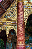 Luang Prabang, Laos - Wat Xieng Mouan with the faade decorated with brightly painted Jataka tales.